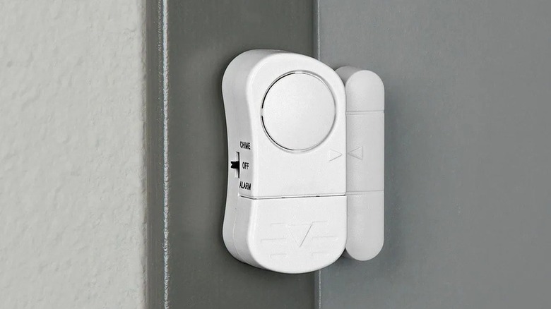 Close up of an entry alarm installed on a door frame