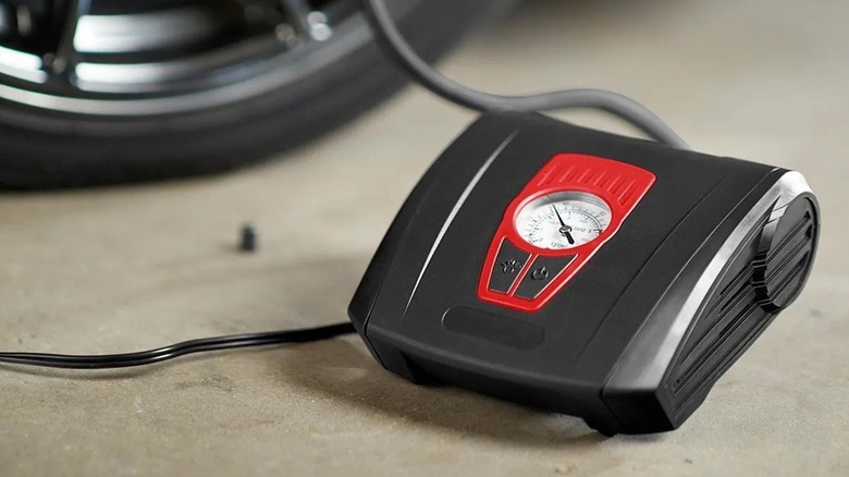 A tire inflator being used on a tire