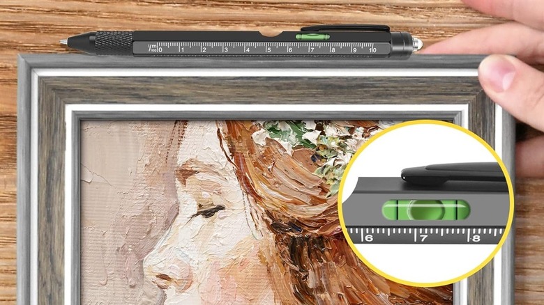 Multitool pen used to level a painting on the wall.