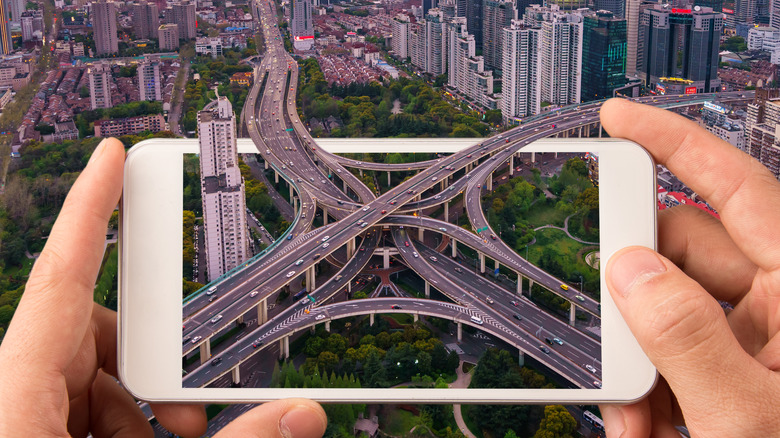 smartphone integrated with the skyline of Shanghai