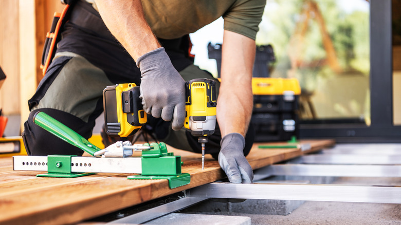 installign floor boards with a collection of tools
