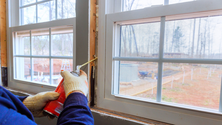 Person sealing windows