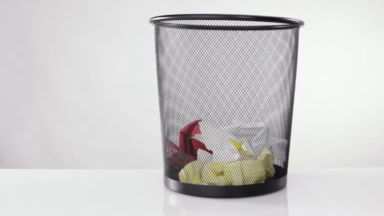 Wire trash can on floor