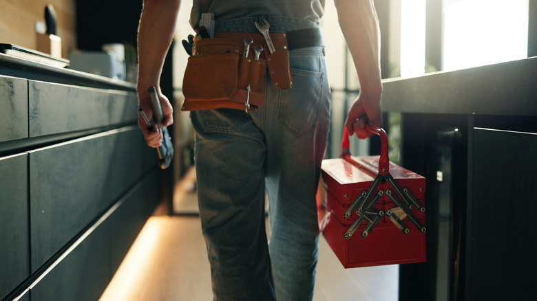 Person walking with tool box