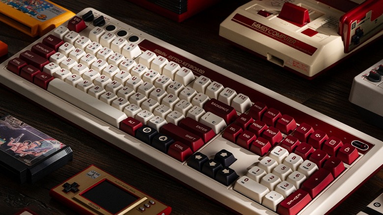The 8BitDo Retro 108 Famicom Edition mechanical keyboard on a desk.