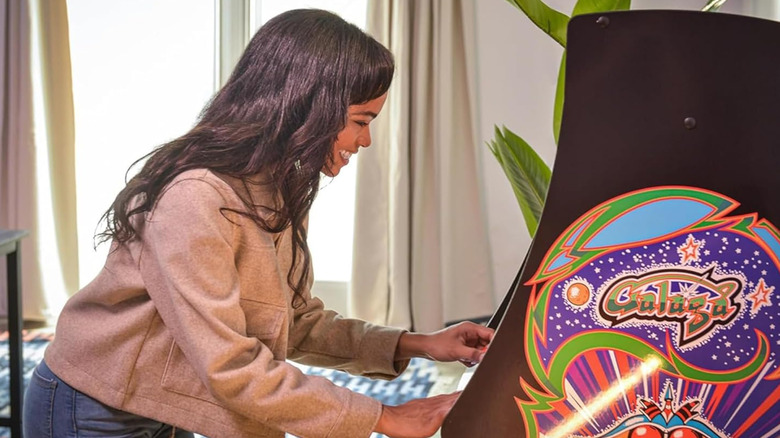 A person playing with the Arcade1Up Class of '81 Deluxe arcade cabinet.