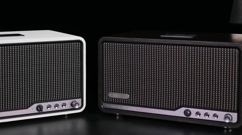 Two Edifier S300 speakers on a black surface.
