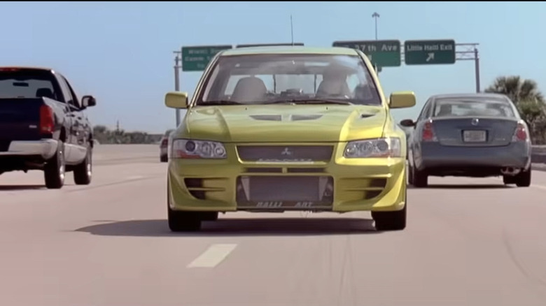 A green Mitsubishi Eclipse driven by Brian O'Connor (Paul Walker) in "2 Fast 2 Furious" going backwards on a highway.