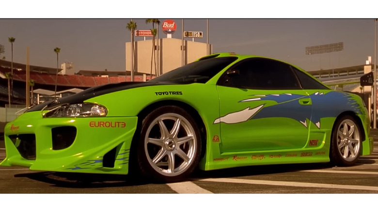 A bright green Mitsubishi Eclipse with a blue livery from the initial movie in the Fast and Furious franchise.