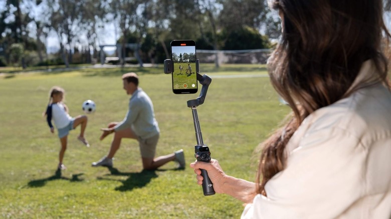 A woman filming with a DJI tripod
