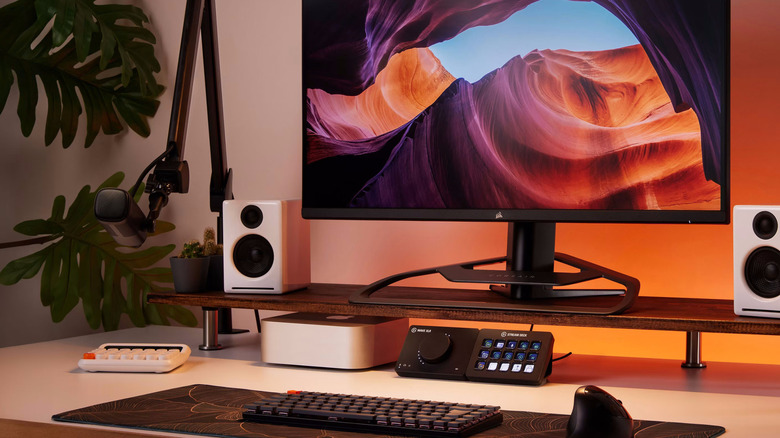 Desk setup with a monitor, keyboard, mouse, microphone, speakers, and a Stream Deck