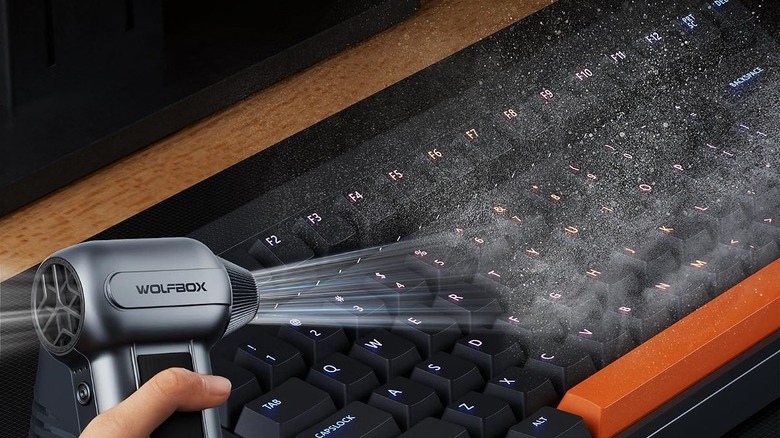 Wolfbox compressed air duster used on a keyboard