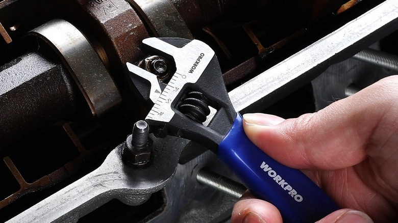 The Workpro mini adjustable wrench used to tighten a nut