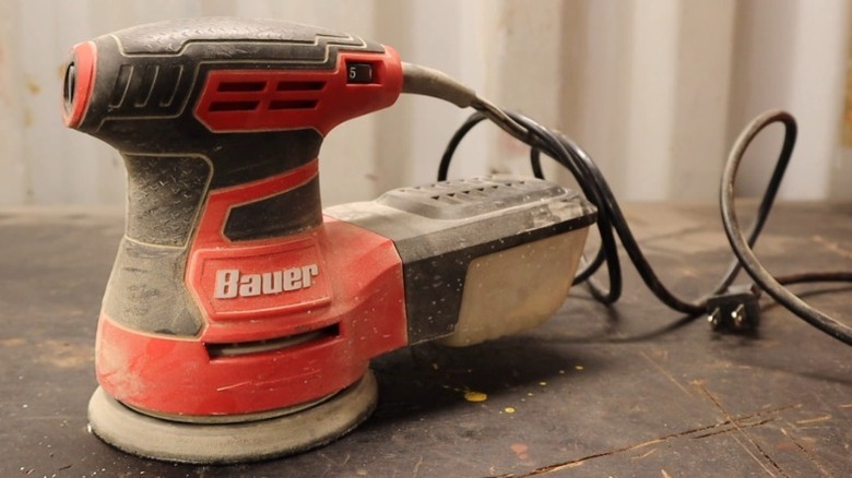 Dusty Bauer random orbit palm sander on a table