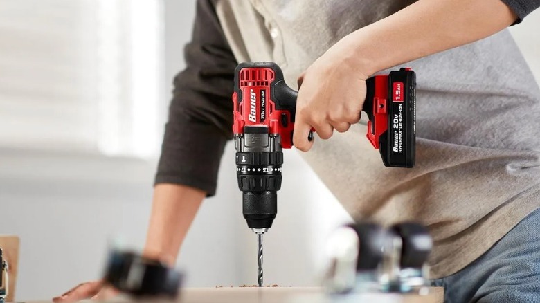 Person using Bauer drill driver to drill into wood