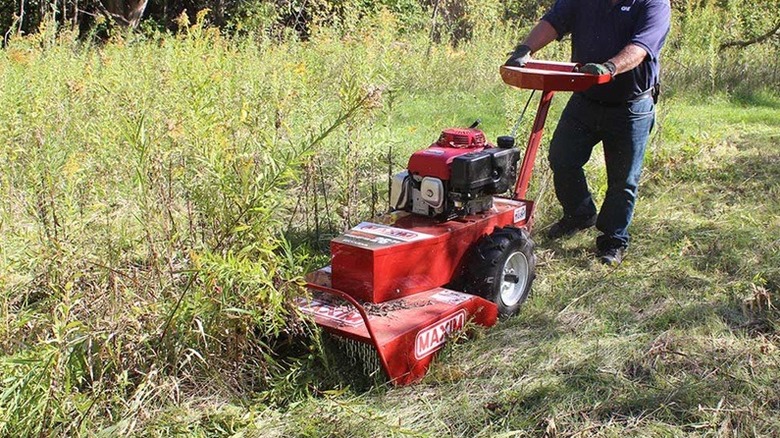Person using Maxim brush cutter