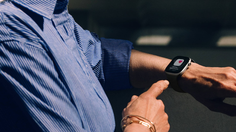 Person wearing an Apple Watch displaying an atrial fibrillation notification.