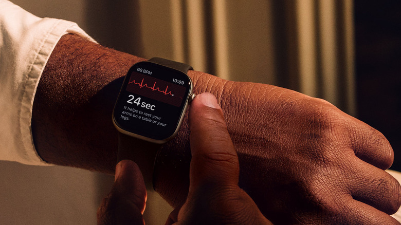 Person administering themself the ECG test on an Apple Watch
