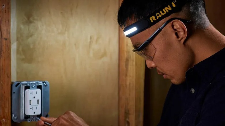 working on a plug while wearing Braun headlamp