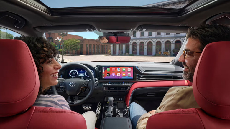 Two people in a Toyota Camry