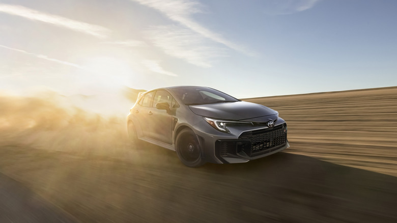2025 Toyota GR Corolla drifting on dirt road front 3/4 view