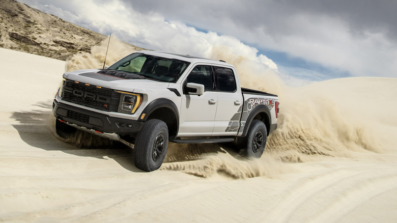 2025 Ford F-150 Raptor R cornering on sand dunes at high speed