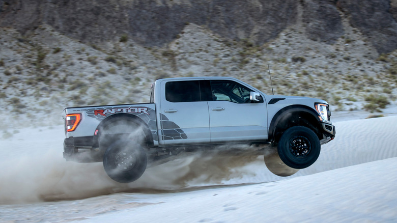 2025 Ford F-150 Raptor R jumping on dunes side view