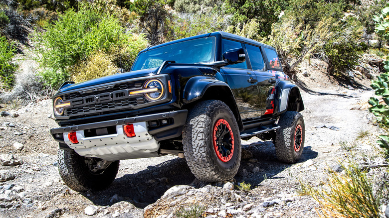 2025 Ford Bronco Raptor off-roading over a rocky surface
