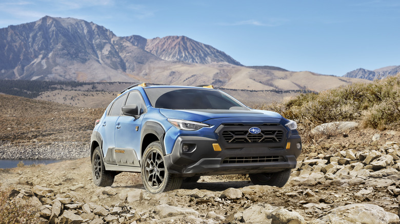 2025 Subaru Crosstrek Wilderness over a rocky trail front 3/4 view