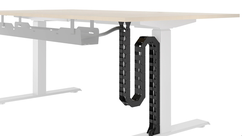 The cable vertebrae mounted under a standing desk