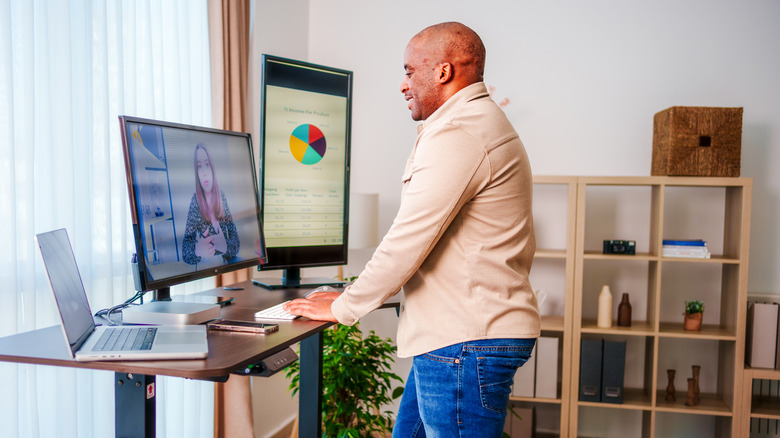 A man working from home at a standing desk