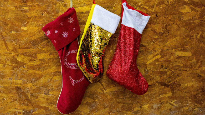 Set of three stockings attached to a plywood backdrop
