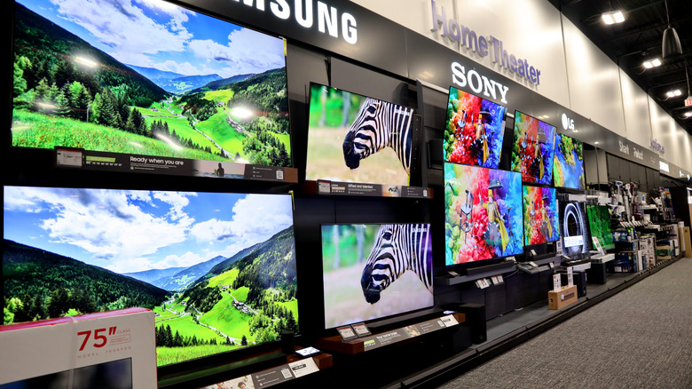 Various smart TVs on display in a store