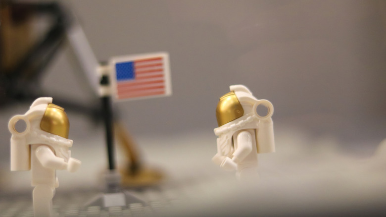 Lego astronauts with the American flag in the background