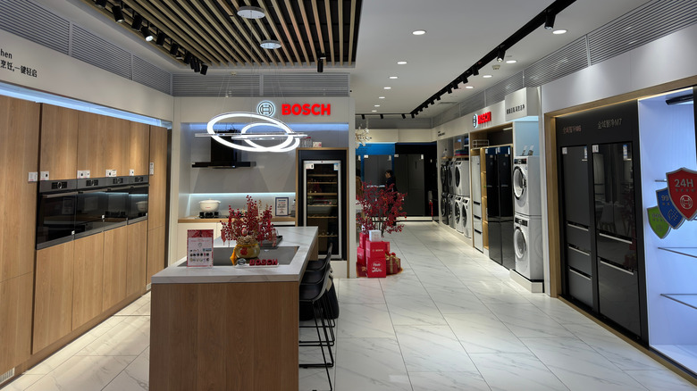 A modern appliance showroom with home and kitchen appliances and a BOSCH logo.