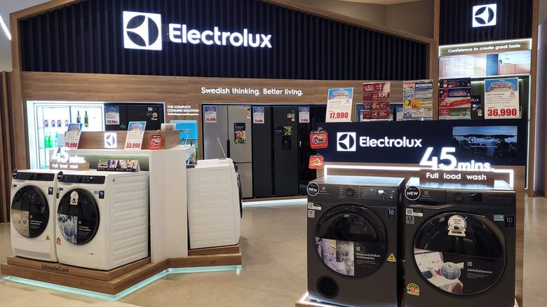 A branded Electrolux retail highlighting front-load washing machines and multi-door refrigerators.
