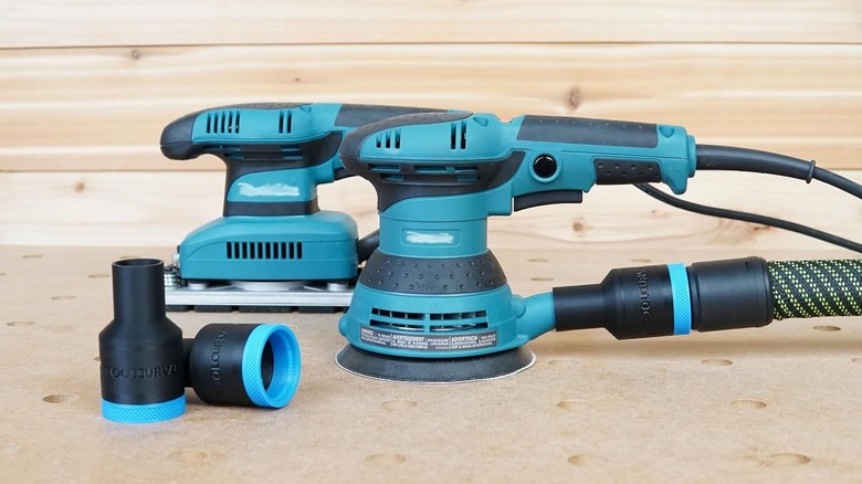 The hose adapter connected to the back of the Makita sander and dust collector