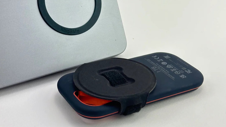 An external SSD hard drive with the terabiter Halo and a MacBook