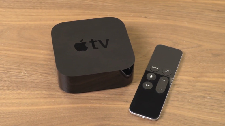 Apple TV HD with remote on a wooden surface