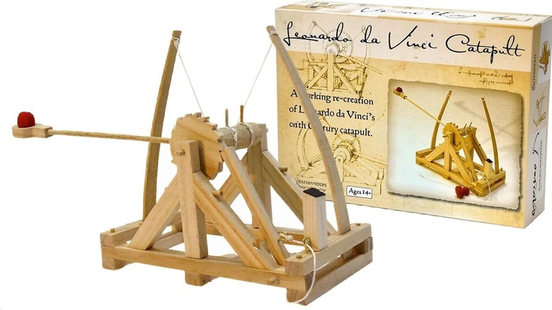 An assembled catapult next to its box