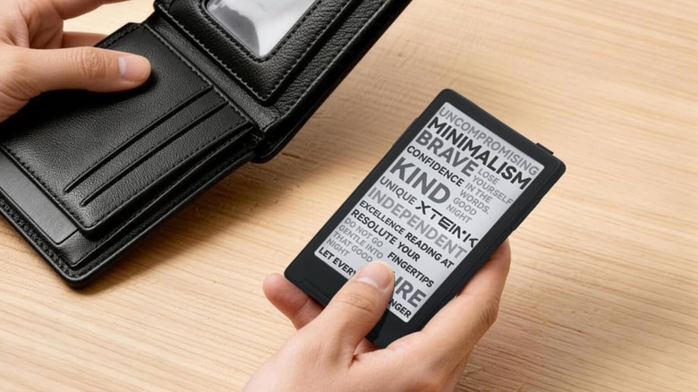 A person holding a wallet in one hand and the XTEINK X3 3.7