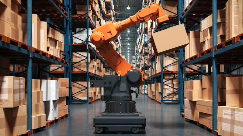 A robotic arm handling boxes in a warehouse