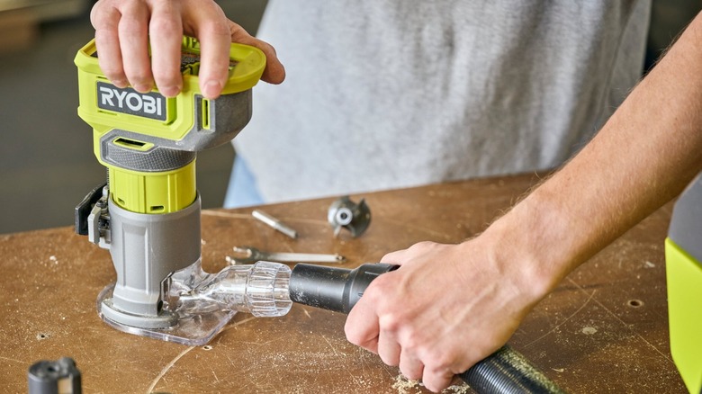 holding Ryobi router on table