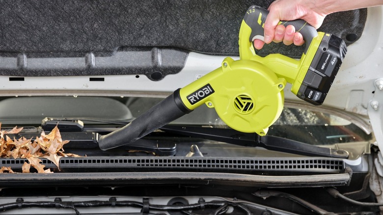 blowing leaves out of car components