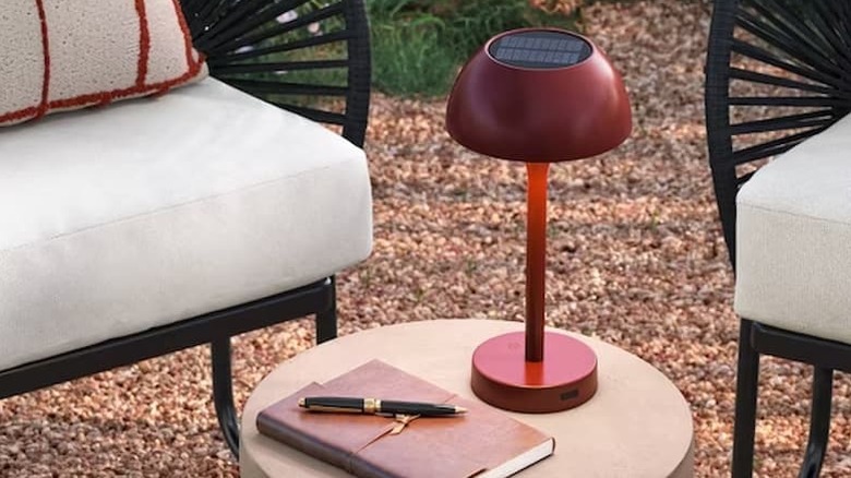 Solar and Rechargeable USB LED Outdoor Table Lamp on a table outside.