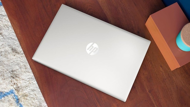 A silver HP Laptop 15 on a table.
