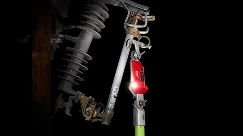 Close-up of a Milwaukee Utility Hot Stick Light hooked onto a fuse
