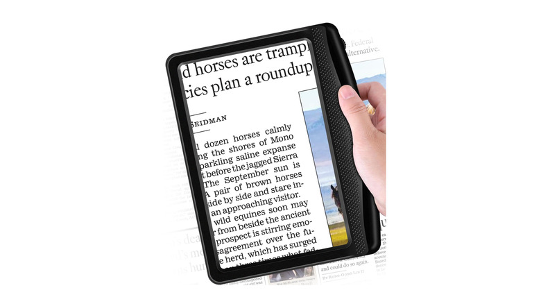 A magnifying glass reader being used on a newspaper