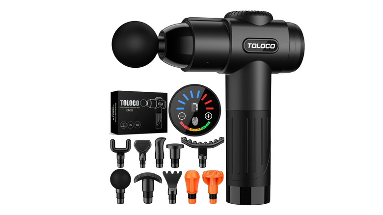 A massage gun with all its attachments on a white background