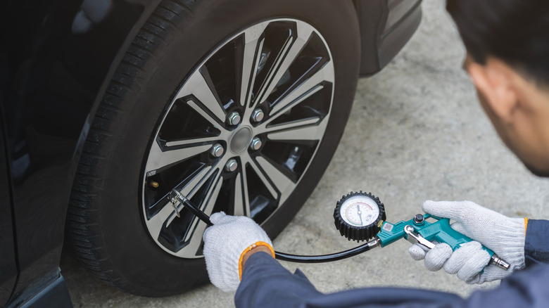 A mechanic checking tire pressure